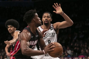 Brooklyn Nets point guard Spencer Dinwiddie on defense against Miami Heat forward Jimmy Butler, with Nets center Jarrett Allen at the ready at the Barclays Center on Sunday, December 1, 2019. 