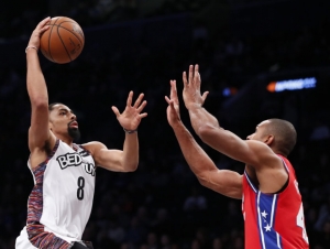 Spencer Dinwiddie, Brooklyn Nets guard going for a dunk with Philadelphia 76ers center Al Horford guarding basket at a game at the Barclays Center in Brooklyn, NY, on Sunday, December 15, 2019. 