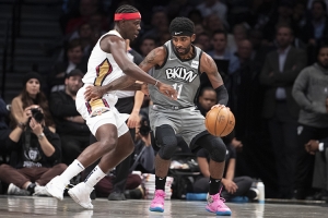 Brooklyn Nets guard Kyrie Irving holding off New Orleans Pelicans guard Jrue Holiday at the Barclays Center on Monday, November 4, 2019.  Brooklyn Nets defeat the New Orleans Pelicans 135-125