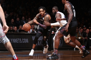 Brooklyn Nets guard D’Angelo Russell in traffic between two Philadelphia 76ers players and Nets Ed Davis (far right) looking on in Game 3 of the Eastern Conference NBA Playoffs on April 18, 2019, at the Barclays Center in Brooklyn, NY.