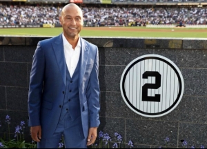 Derek Jeter, former shortstop for the New York Yankees, standing next to the symbolic No. 2 at his retirement ceremony at Yankees Stadium.
