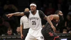 Brooklyn Nets forward, Trevor Booker (left), entangled with Houston Rockets guard James Harden during the first half of game at Barclays Center on January 15, 2017.  