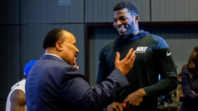Martin Luther King talking with a member of the NY Giants at a civic engagement event sponsored by RISE, a nonprofit organization founded by Miami Dolphins owner Stephen M. Ross