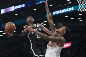 Brooklyn Nets guard Caris LeVert drives a jump shot over New York Knicks forward Lance Thomas to put the Nets up 107-105 over the Knicks with one second left in regulation for the eventual win.