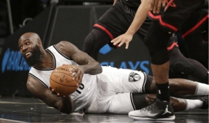 Brooklyn Nets&#039; Quincy Acy, on the floor scrambling for the ball in a game against the Houston Rockets at the Barclays Center on Sunday, January 15, 2017.