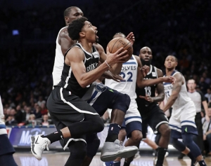 Brooklyn Nets&#039; Spencer Dinwiddie, left, drives past Minnesota Timberwolves&#039; Gorgui Dieng during an NBA basketball game on Wednesday, Jan. 3, 2018, at the Barclays Center in Brooklyn, New York. The Nets won 98-97.