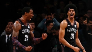 Brooklyn Nets forward Rondae Hollis-Jefferson (left) and Brooklyn Nets center Jarrett Allen (right) jubilant after defeating the Toronto Raptors 106-105 in overtime at Barclays Center.