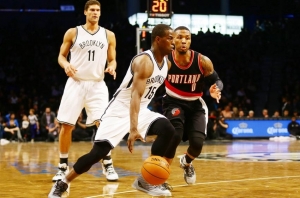 Isaiah Whitehead being defended by Portland Trail Blazers guard Damian Lillard with Brook Lopez in background