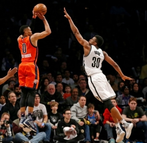 Thaddeus Young Brooklyn Nets forward defending basket against OKC guard Russell Westbrook