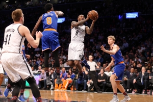 Sean Kilpatrick, Brooklyn Nets shooting guard, goes to the basket surrounded by New York Knicks players.