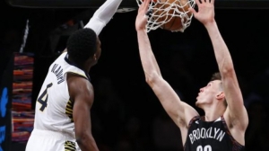 Brooklyn Nets rookie Rodions Kurucs attempting to block Indiana Pacers guard Victor Oladipo from scoring