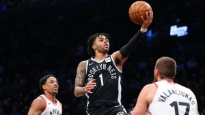 Brooklyn Nets guard D&#039;Angelo Russell (center) goes to the basket against Toronto Raptors guard DeMar DeRozan (left) and center Jonas Valanciunas (right) during second half at Barclays Center; Brooklyn, NY, USA; on March 13, 2018. 
