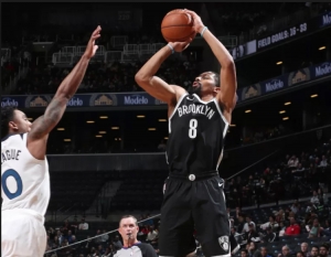 Brooklyn Nets guard Spencer Dinwiddie scoring over Minnesota Timberwolves guard Jeff Teague at a game at the Barclays Center on Friday, November 23, 2018