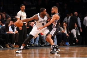 Brooklyn Nets guard Donald Sloan drives against San Antonio Spurs guard Patty Mills