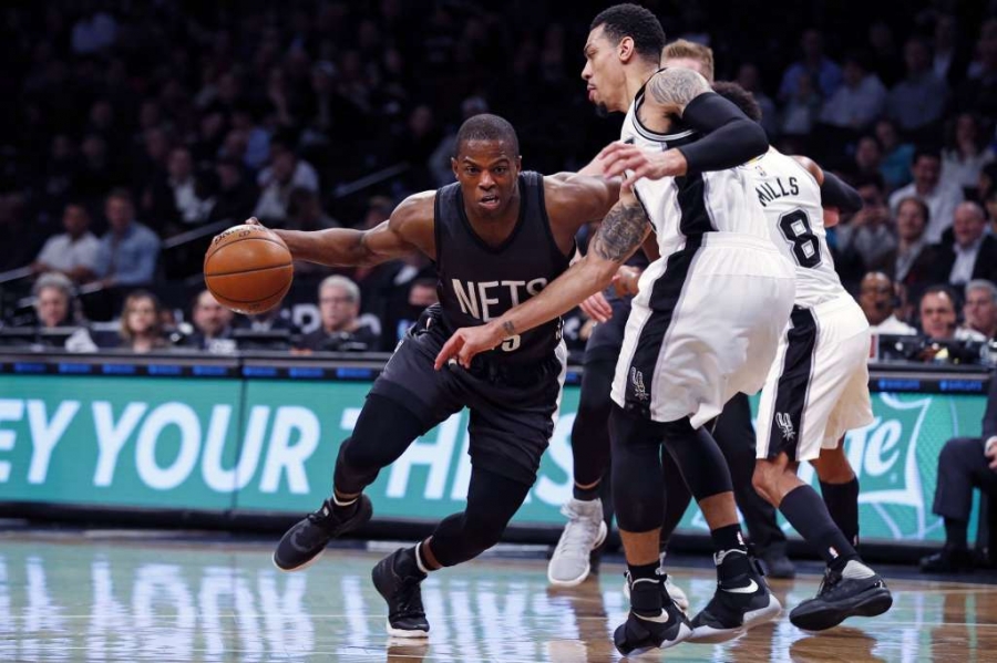 Brooklyn Nets guard Isaiah Whitehead drives to the basket defended by San Antonio Spurs guard Danny Green