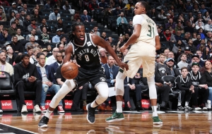 DeMarre Carroll, Brooklyn Nets forward, gets by Milwaukee Bucks center John Henson at game at the Barclays Center in Brooklyn on February 4, 2018.