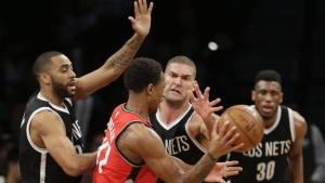 Brooklyn Nets center Brook Lopez putting defensive moves on Toronto Raptors&#039; DeMar DeRozan