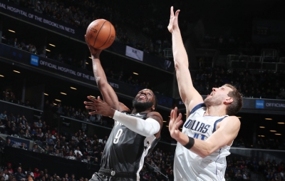 Brooklyn Nets forward DeMarre Carroll going up to score a basket with Dallas Mavericks forward Dirk Nowitzki defending on March 4, 2019, at the Barclays Center in Brooklyn, NY