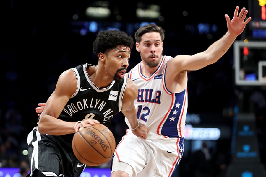 Spencer Dinwiddie, Nets point guard, driving past Sixers TJ McConnell on January 1, 2018, at the Barclays Center