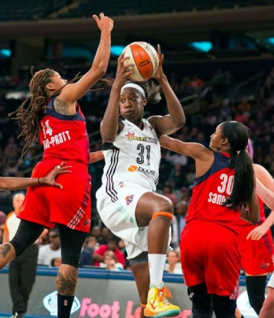 New York Liberty center Tina Charles surrounded by Washington Mystics players goes up for two points