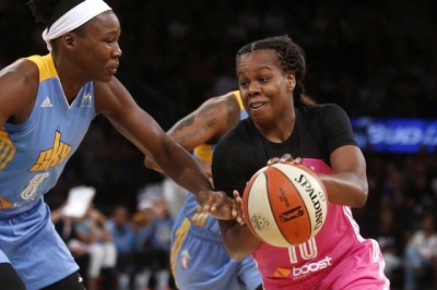 Epiphanny Prince defending the ball against a Chicago Sky player 